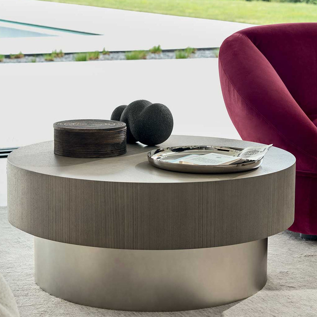 Modern living room with a round coffee table and a red armchair.