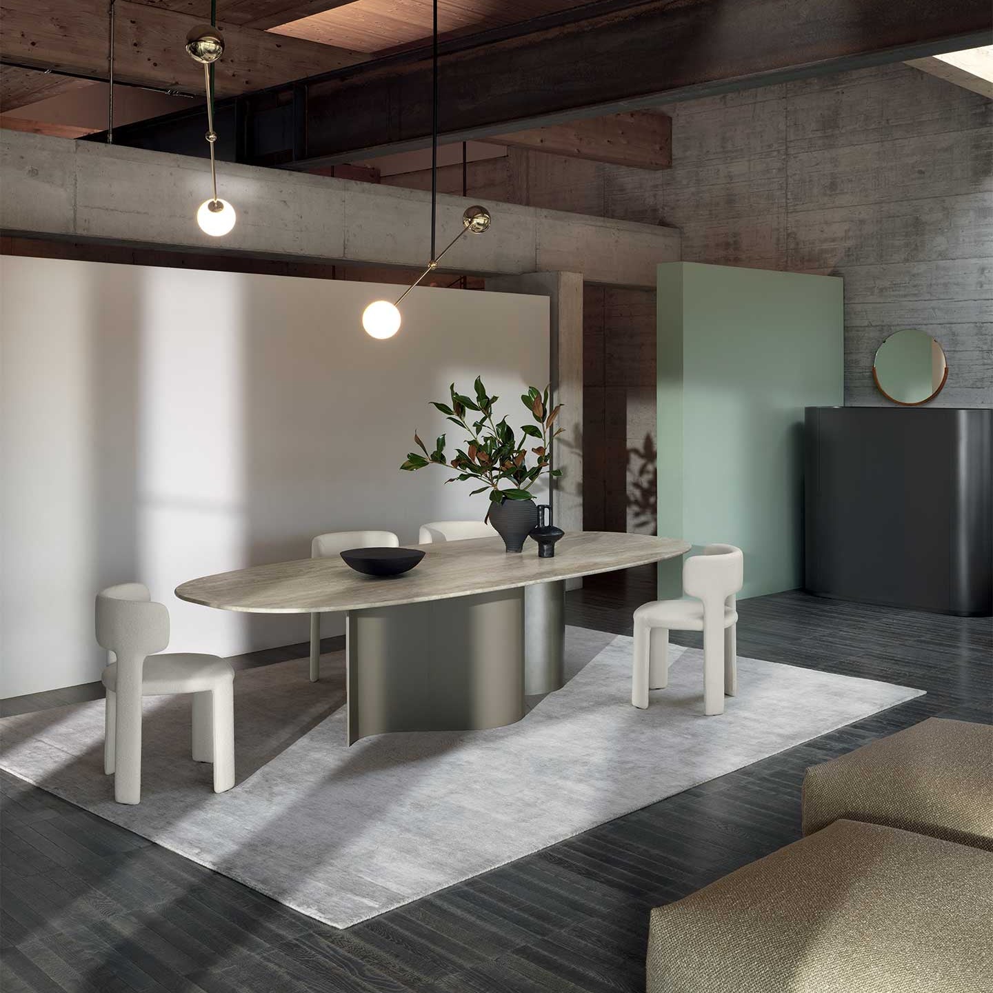 Modern dining room with a wooden table and chairs, pendant lights, and a concrete wall.