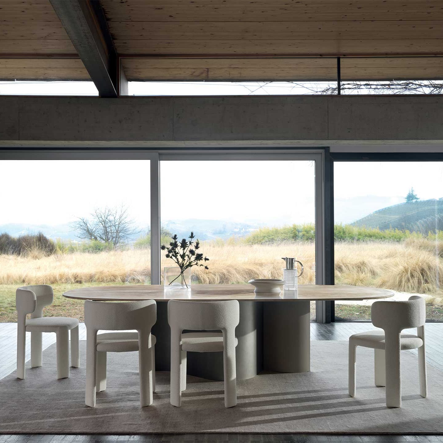 Modern dining area with a large window view of a scenic landscape.