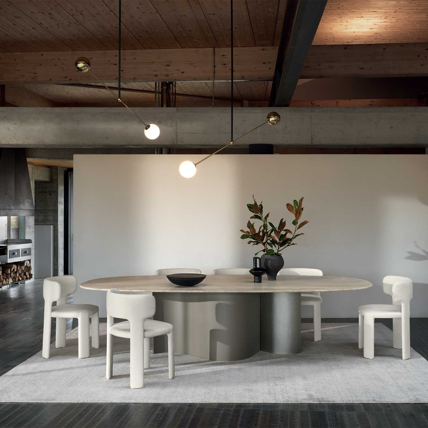 Modern dining area with a round table and chairs in a stylish room.