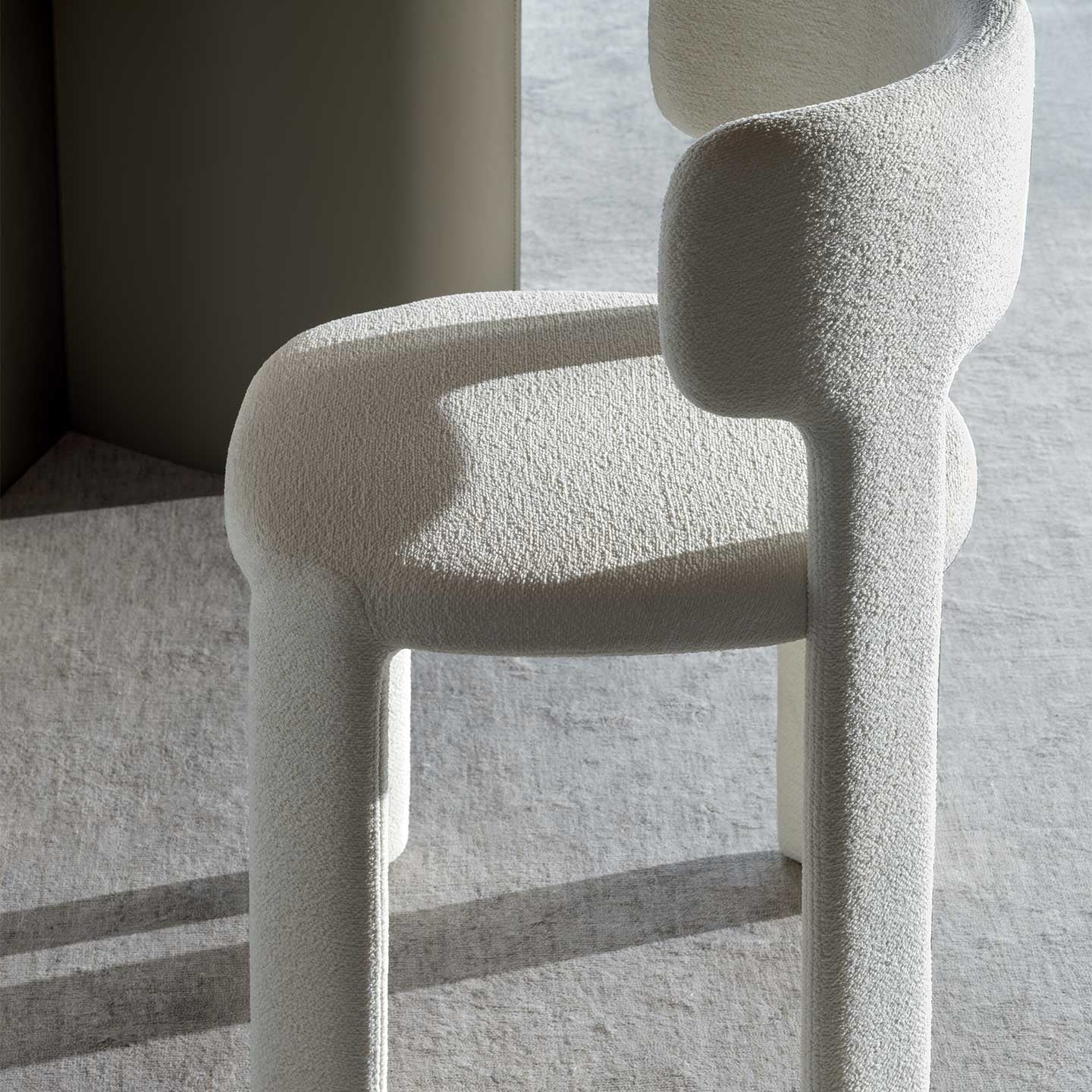 Modern chair with textured design on a light gray floor