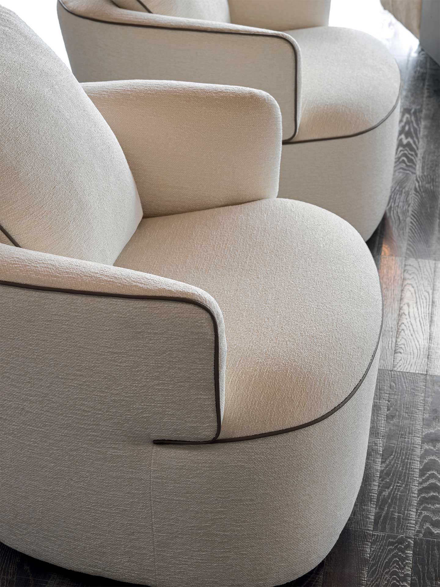 Close-up of a beige armchair with a blurred background