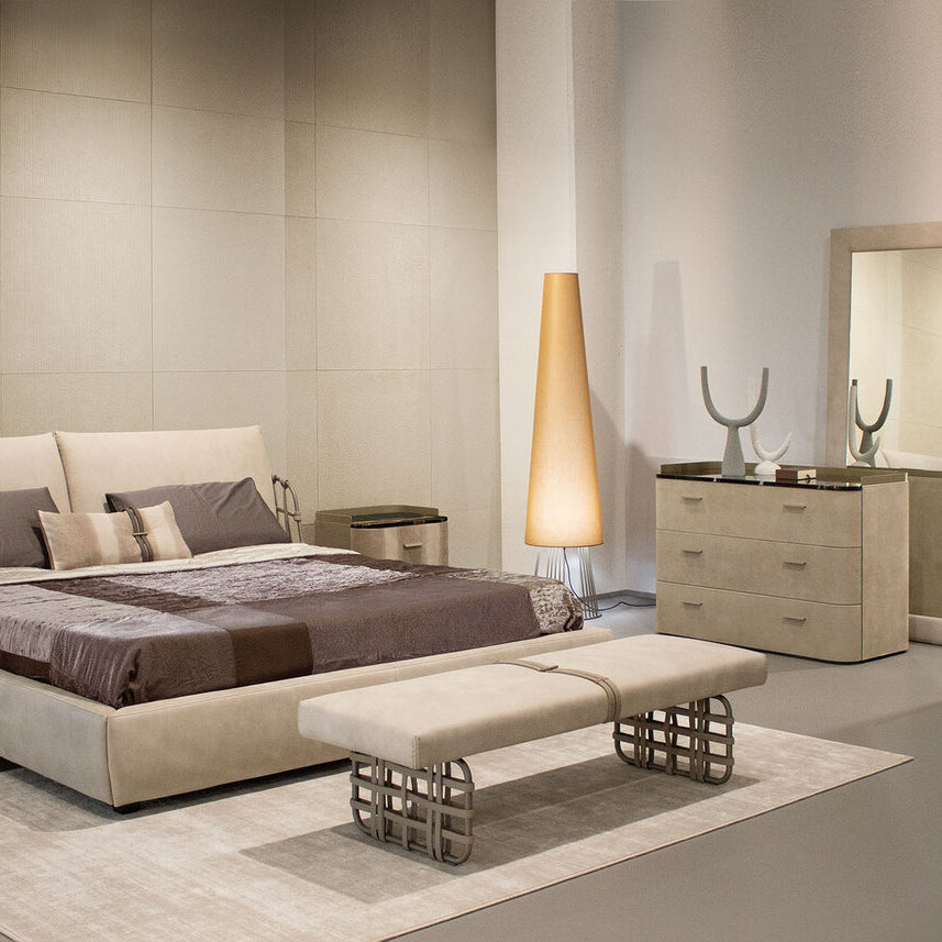 Modern bedroom with beige furniture including a bed, nightstands, and wardrobe.