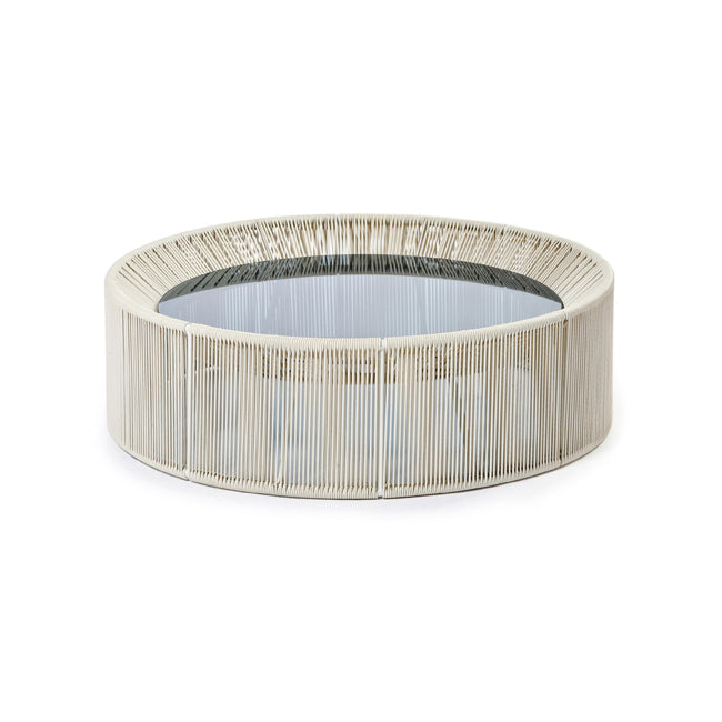 A circular coffee table with a beige powder-coated aluminium frame and a wicker weave top.