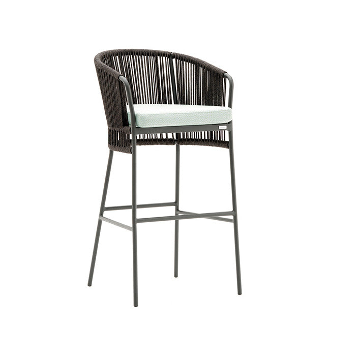 A slender, gray aluminum and wicker barstool with a full backrest and a seat without a cushion.