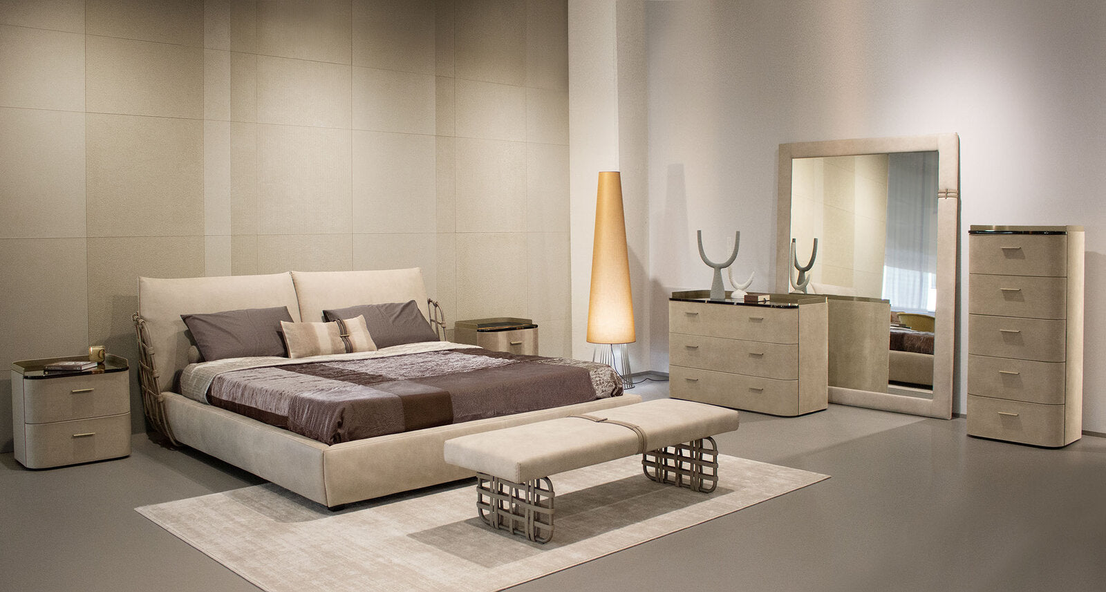 Modern bedroom with beige furniture including a bed, nightstands, and wardrobe.